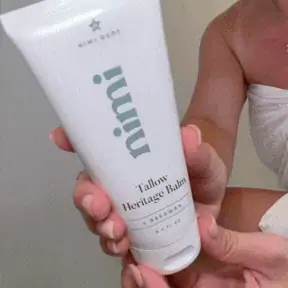 Smoothing the Tallow Heritage Balm over the skin